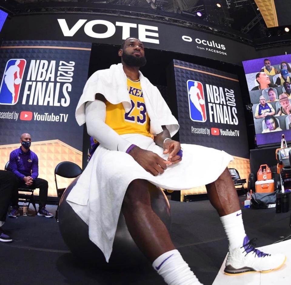 Former Michigan State basketball team manager Andrew Henk had one of the best seats in the NBA's bubble. Here, the equipment manager sits courtside during the NBA finals just behind LeBron James' shoulder.