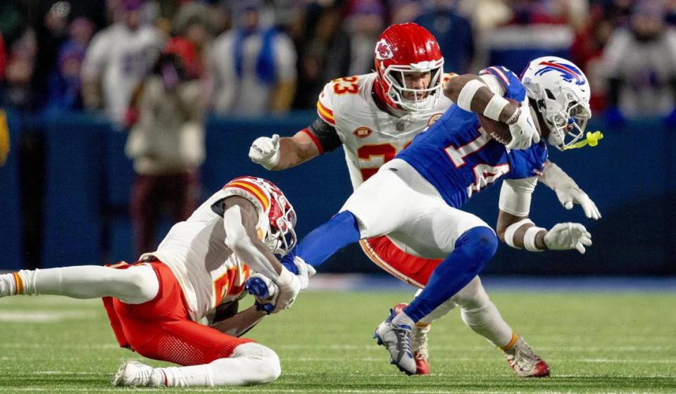 Kansas City Chiefs cornerback Joshua Williams (2) wraps up Buffalo Bills wide receiver Stefon Diggs (14) during an AFC Divisional Round playoff game at Highmark Stadium on Sunday, Jan. 21, 2024, in Orchard Park, New York.