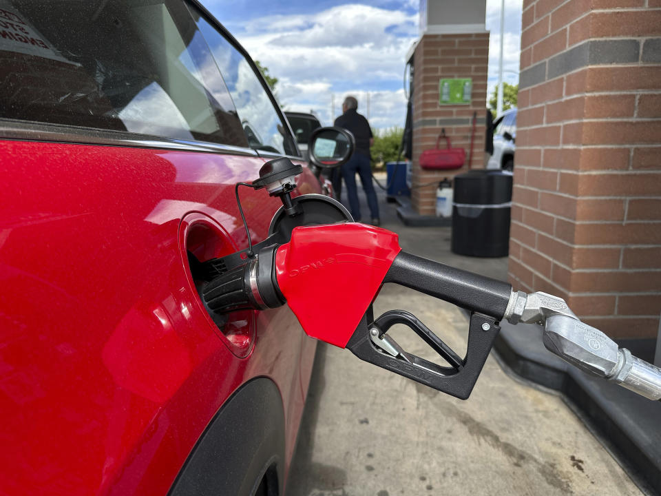 A motorist fills up the tank of an automobile at a Costco warehouse gasoline station Thursday, June 27, 2024, in Sheridan, Colo. (AP Photo/David Zalubowski)