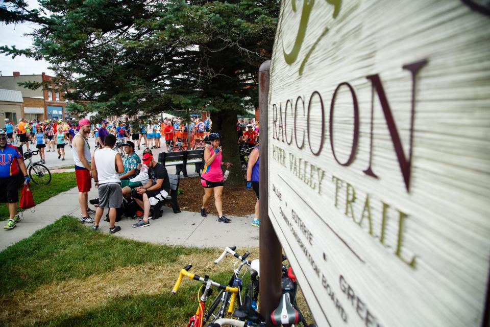 Cyclists take a break in Dallas Center on the Raccoon River Valley trail during the BACooN ride.