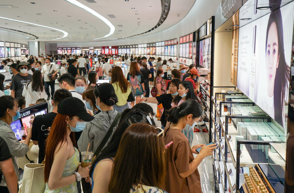 Customers shop for cosmetics at Sanya International Duty Free Shopping Complex. - Credit: VCG via Getty Images
