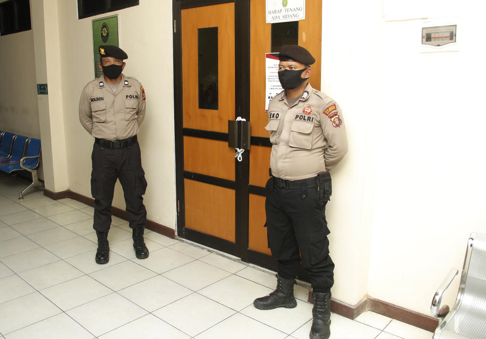 Police officers stand guard outside the courtroom where the virtual sentencing hearing for seven Papuan pro-independence activists who are on trial on the accusation of treason is held, at a district court in Balikpapan, East Kalimantan, Indonesia, Wednesday, June 17, 2020. The court sentenced the activists to nearly yearlong jail terms on treason charges for organizing anti-racism protests last year, despite calls from rights groups and politicians to drop the charges and release them. (AP Photo/Andi Muhammad Hafizh)