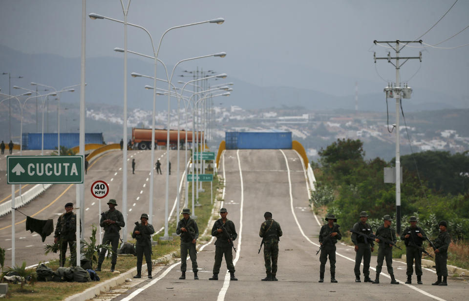 Venezuelan Bolivarian Army soldiers stand guard at the Tienditas International Bridge that links Colombia and Venezuela, near Urena, Venezuela, Friday, Feb. 8, 2019. As humanitarian aid kits were being packed into individual white bags in the city of Cucuta, just across the river from Venezuela, U.S. officials and Venezuelan opposition leaders appealed to the military to the let the aid through. (AP Photo/Fernando Llano)