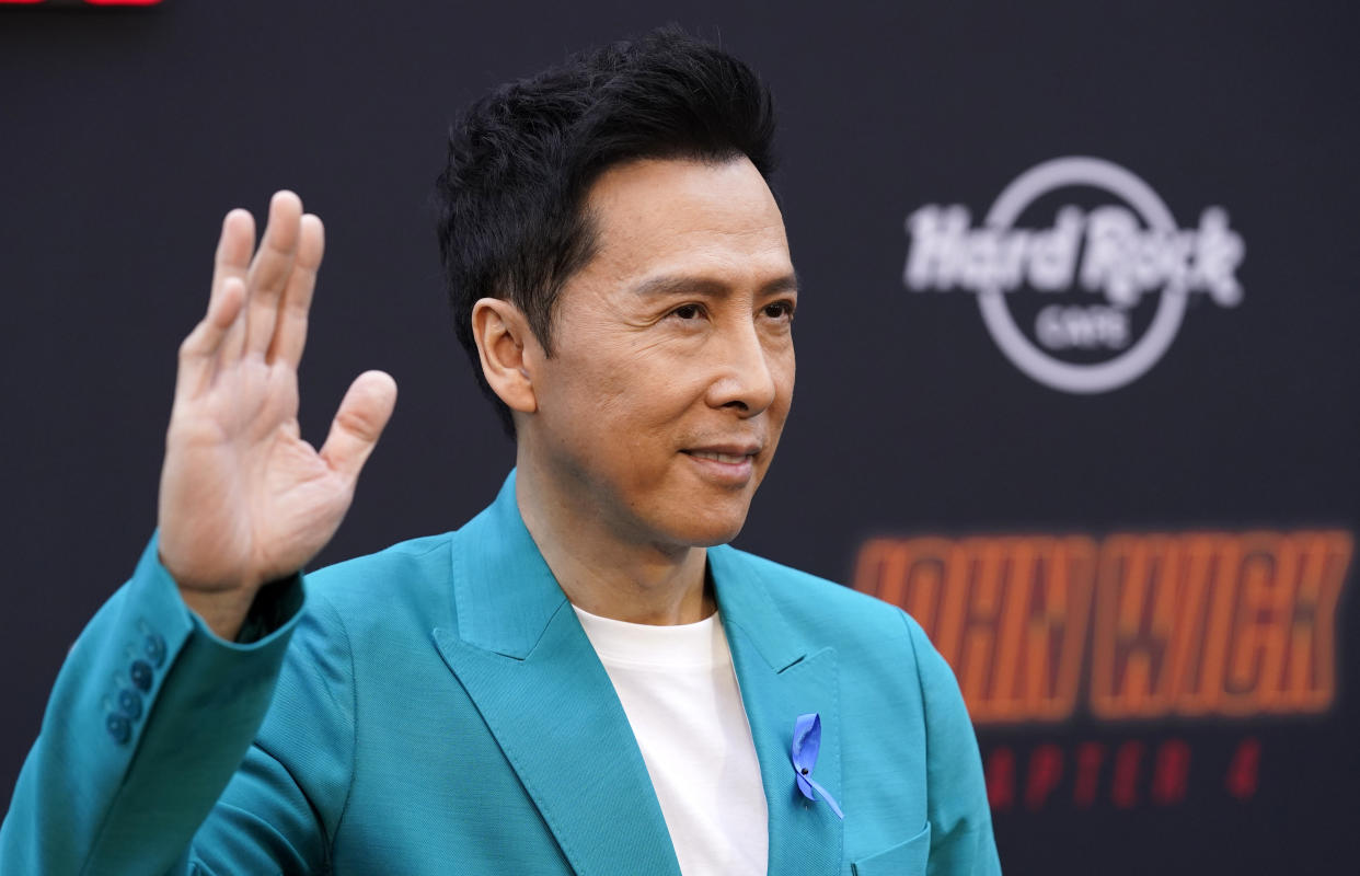 Donnie Yen, a cast member in "John Wick: Chapter 4," waves at the premiere of the film, Monday, March 20, 2023, at the TCL Chinese Theatre in Los Angeles. (AP Photo/Chris Pizzello)