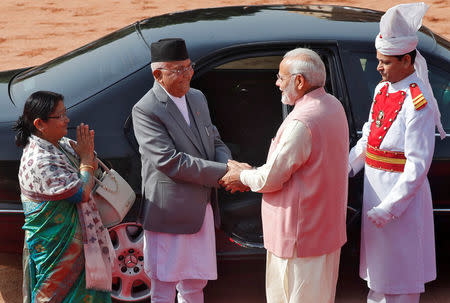 Nepal's Prime Minister Khadga Prasad Sharma Oli (2nd L) shakes hands with his Indian counterpart Narendra Modi (2nd R) as his wife Radhika Shakya Oli (L) gestures during Oli's ceremonial reception at the forecourt of India's Rashtrapati Bhavan presidential palace in New Delhi, India, April 7, 2018. REUTERS/Altaf Hussain