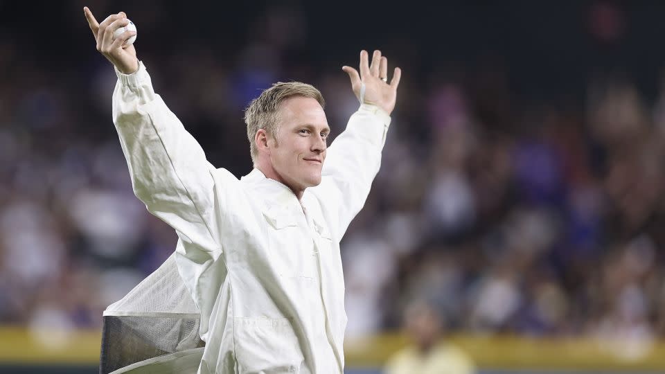 Beekeeper Hilton hypes up the crowd after removing the swarm of bees. - Christian Petersen/Getty Images