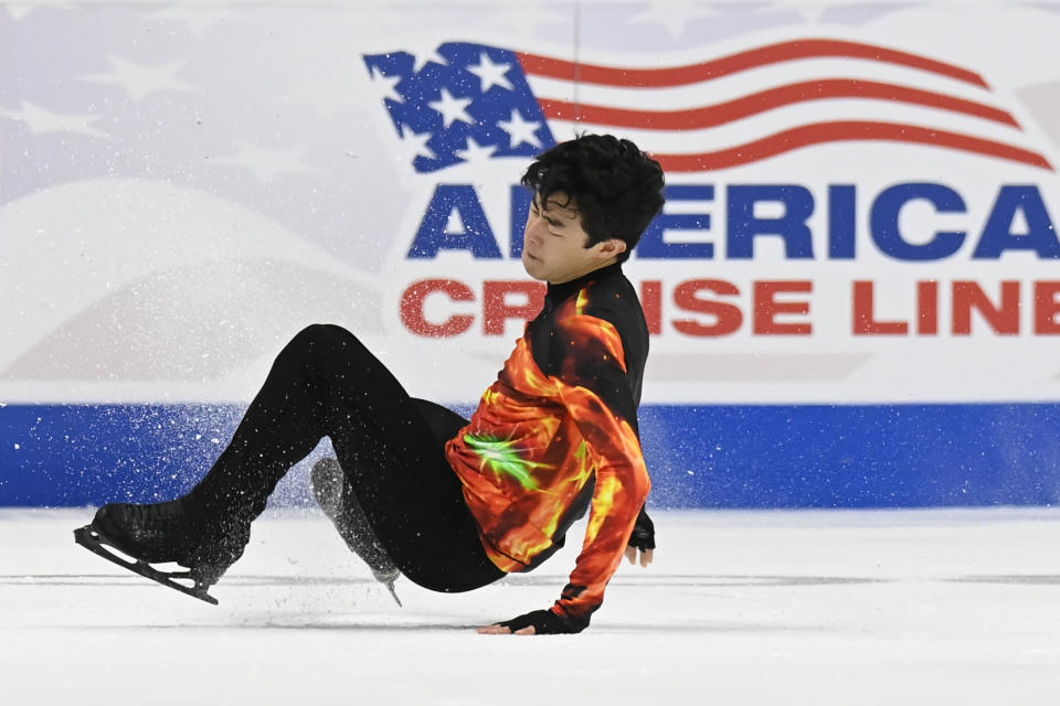 Nathan Chen falls in the men's free skate program during the U.S. Figure Skating Championships Sunday, Jan. 9, 2022, in Nashville, Tenn. (AP Photo/Mark Zaleski)