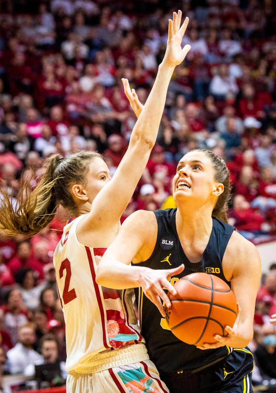 Michigan's Emily Kiser (33) shoots past Indiana's Yarden Garzon (12) during the first half of the Indiana versus Michigan women's basketball game at Simon Skjodt Assembly Hall on Thursday, Feb. 16, 2023.