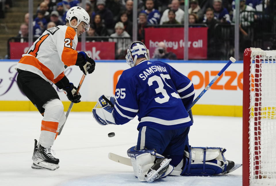 Toronto Maple Leafs goaltender Ilya Samsonov (35) makes a save as Philadelphia Flyers' Scott Laughton (21) watches during the first period of an NHL hockey game Wednesday, Nov. 2, 2022, in Toronto. (Frank Gunn/The Canadian Press via AP)