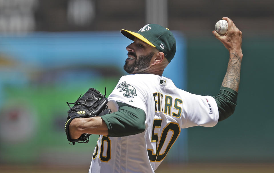 FILE - In this May 25, 2019, file photo, Oakland Athletics pitcher Mike Fiers works against the Seattle Mariners in the first inning of a baseball game in Oakland, Calif. Fiers and the Athletics might have reason to be downright mad. They won 97 games each of the past two seasons to finish as the second-place team in the AL West behind the Houston Astros, whom Fiers called out in November in a story by The Athletic for a sign-stealing scheme that led to season-long MLB suspensions for Astros general manager Jeff Luhnow and manager AJ Hinch. Fiers insisted at Fan Fest that he is moving forward, declining to address anything regarding what he did by speaking out or even his role cleaning up the sport. He said he owes that to his teammates. (AP Photo/Ben Margot, File)