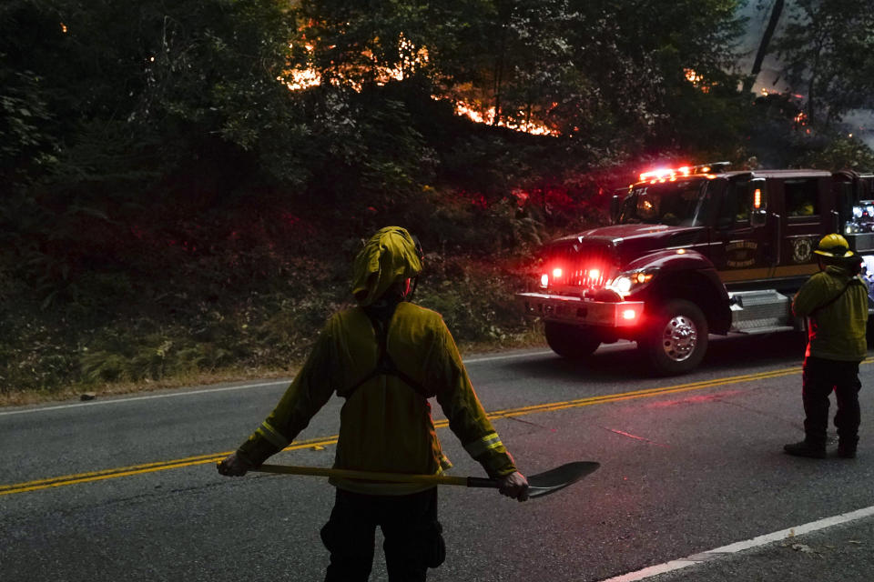 Crews from the Boulder Creek Fire Department keep an eye out on a flare up from the CZU August Lightning Complex Fire along Highway 9, Saturday, Aug. 22, 2020, in Boulder Creek, Calif. (AP Photo/Marcio Jose Sanchez)