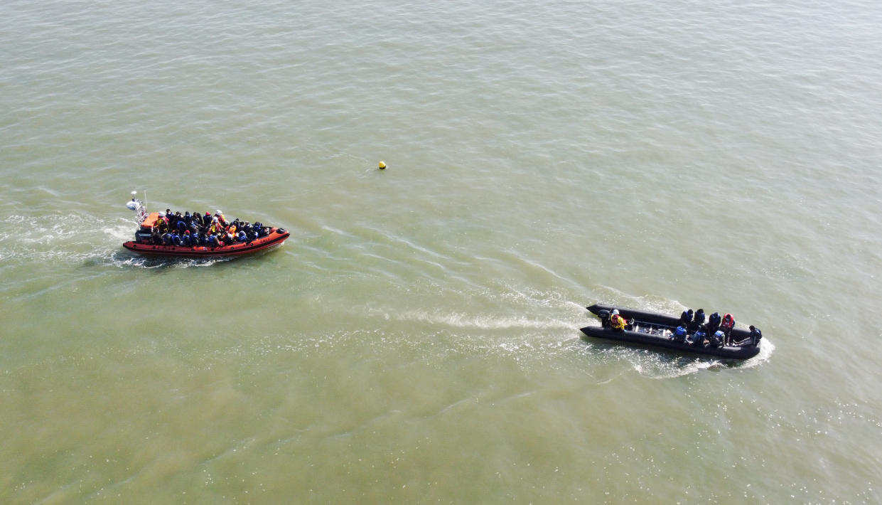 A group of people thought to be migrants are escorted to shore in Kingsdown, Kent, after being intercepted by an RNLI crew following a small boat incident in the Channel. Picture date: Tuesday September 7, 2021.