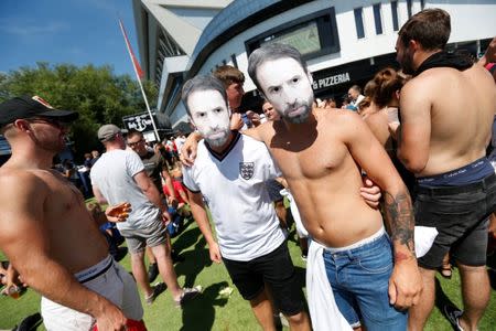 Soccer Football - World Cup - England fans watch Sweden vs England - Bristol, Britain - July 7, 2018 England fans with masks of England manager Gareth Southgate outside Ashton Gate Stadium Action Images via Reuters/Ed Sykes