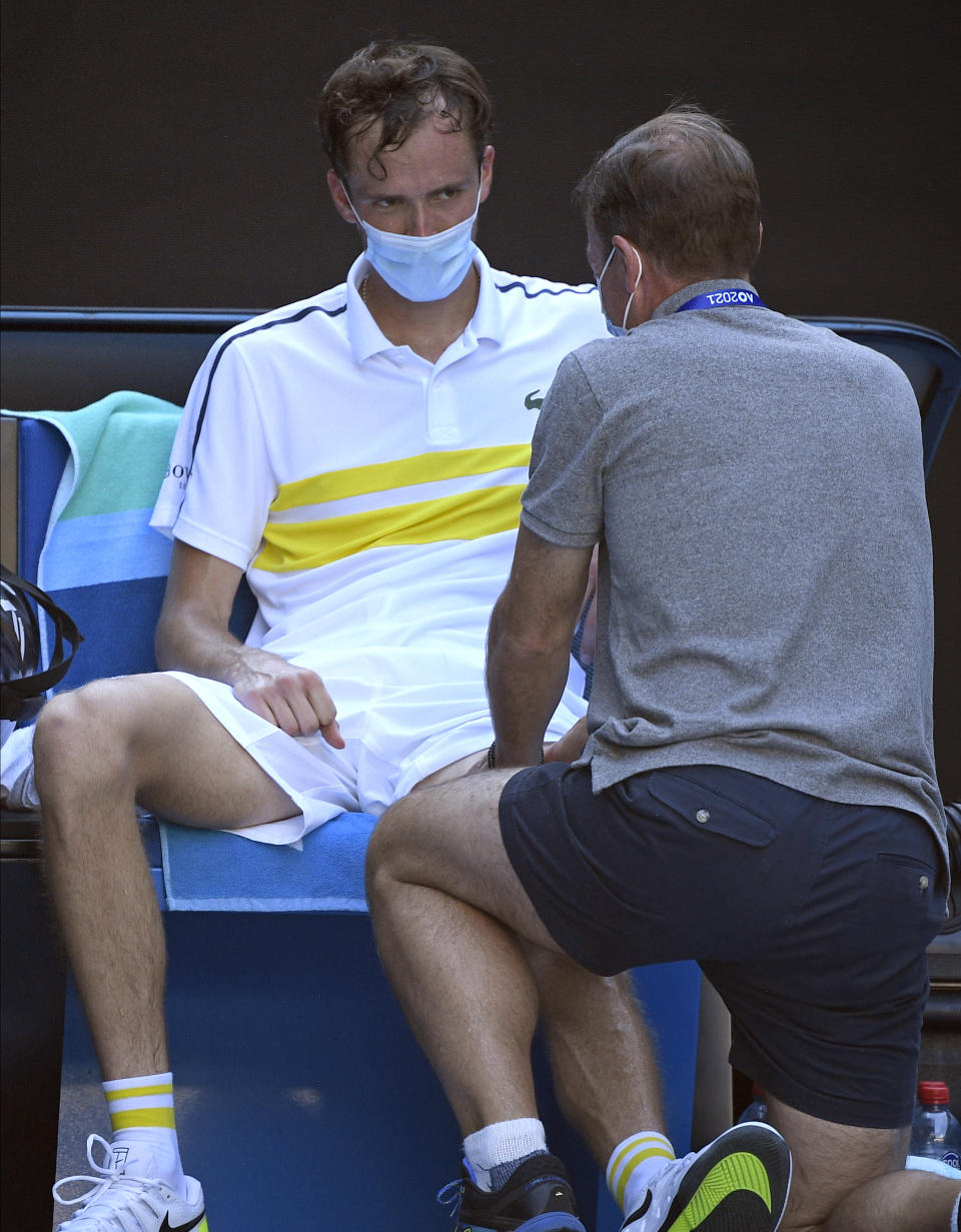 Russia's Daniil Medvedev receives treatment from a trainer after defeating compatriot Andrey Rublev in their quarterfinal match at the Australian Open tennis championship in Melbourne, Australia, Wednesday, Feb. 17, 2021.(AP Photo/Andy Brownbill)