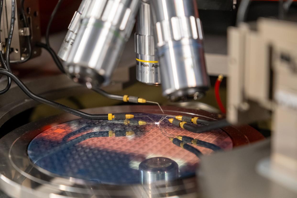 A wafer that can hold up to hundreds of semiconductor chips is positioned for inspection on a Karl Suss probe station, of of several advanced analysis instruments donated to UVM's Device Characterization lab by GlobalFoundries.