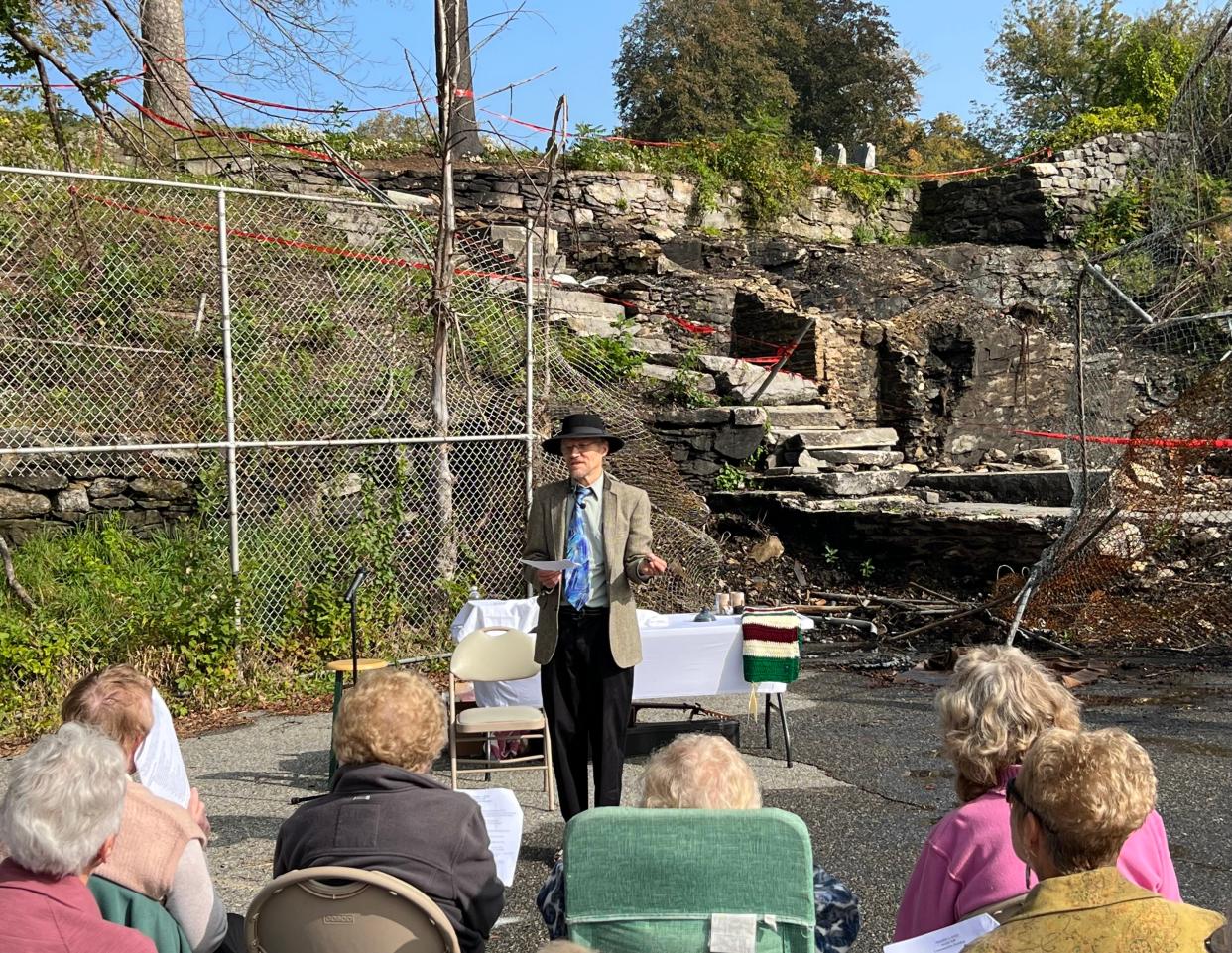 Rev. Bruce MacLeod addresses members of the First Congregational Church of Spencer during a service at the spot where the church once stood, before it was destroyed by fire in June.