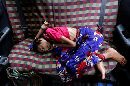 Ranjita Das, a cancer patient waits for treatment inside a taxi during a strike by doctors demanding security after the recent assaults on doctors by the patients' relatives, in Kolkata