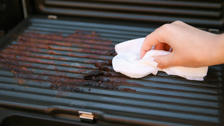 Woman cleaning an electric grill