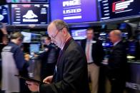 Traders work on the floor at the NYSE in New York