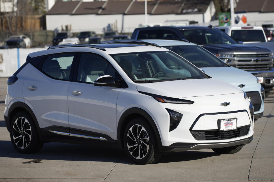 Bolt electric vehicles sit in an empty storage lot at a Chevrolet dealership in Englewood, Colo. (David Zalubowski / AP)