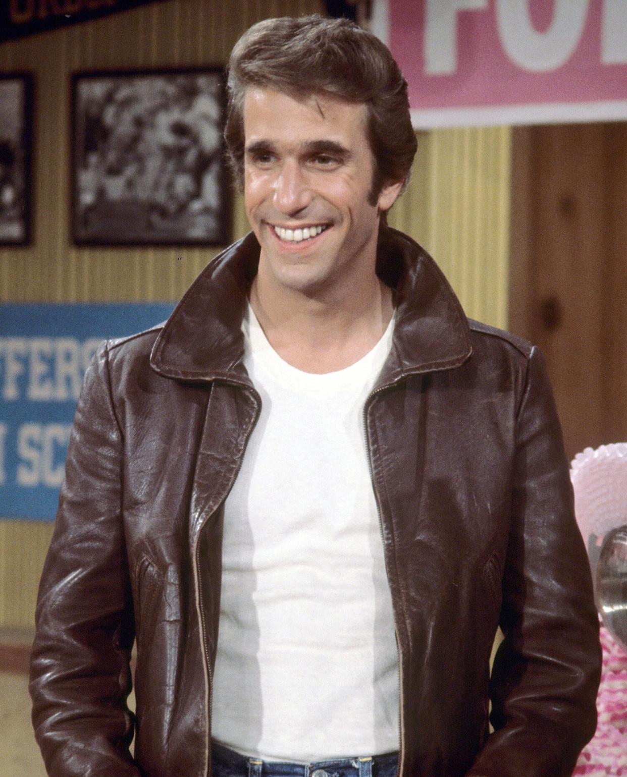 Henry Winkler, US actor, wearing a brown leather jacket and white t-shirt in a publicity still issued for the US television series, 'Happy Days', USA, circa 1977