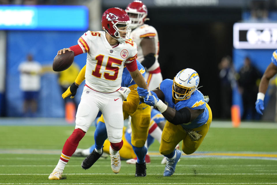 Los Angeles Chargers defensive tackle Sebastian Joseph-Day, right, grabs Kansas City Chiefs quarterback Patrick Mahomes during the first half of an NFL football game Sunday, Nov. 20, 2022, in Inglewood, Calif. (AP Photo/Jae C. Hong)