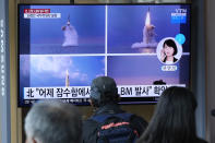 People watch a TV screen showing images of North Korea's ballistic missile launched from a submarine during a news program at Seoul Railway Station in Seoul, South Korea, Wednesday, Oct. 20, 2021. North Korea announced Wednesday that it had tested a newly developed missile designed to be launched from a submarine, the first such weapons test in two years and one it says will bolster its military's underwater operational capability.Korean letters read: on the top of screen read: "North Korea launched a ballistic missile from a submarine." (AP Photo/Ahn Young-joon)