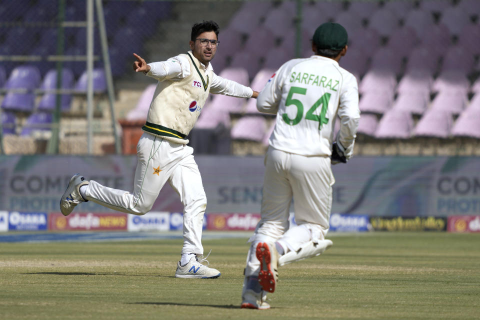 Pakistan's Abrar Ahmed, left, celebrates after taking the catch of New Zealand's Tom Latham during the fourth day of the second test cricket match between Pakistan and New Zealand, in Karachi, Pakistan, Thursday, Jan. 5, 2023. (AP Photo/Fareed Khan)