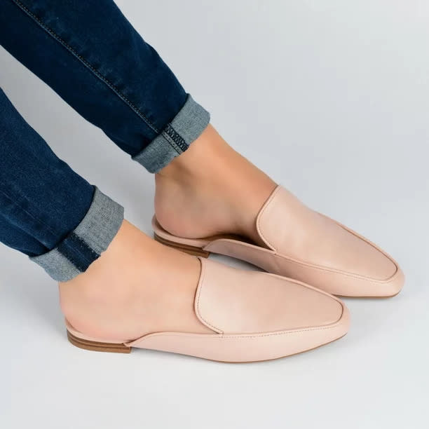 Model wearing the blush mules