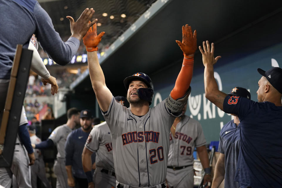 Houston Astros' Chas McCormick (20) celebrates with the team after hitting a solo home run in the ninth inning of a baseball game against the Texas Rangers, Wednesday, Sept. 6, 2023, in Arlington, Texas. (AP Photo/Tony Gutierrez)