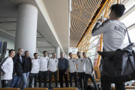 Members of the South Korean football team pose for a photo before boarding an Air China flight to Pyongyang for a World Cup qualifier match against North Korea from the airport in Beijing on Monday, Oct. 14, 2019. (AP Photo/Ng Han Guan)