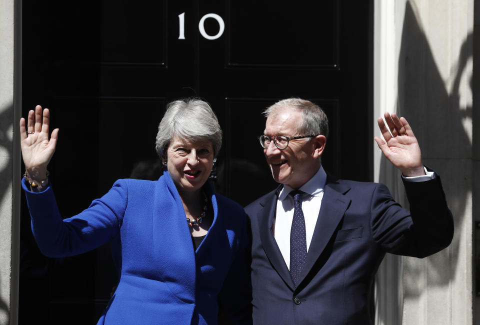Britain's Prime Minister Theresa May and her husband Philip waves from the steps of 10 Downing Street, London before leaving for Buckingham Palace where she will hand her resignation to Queen Elizabeth II, Wednesday, July 24, 2019. Boris Johnson will replace May as Prime Minister later Wednesday, following her resignation last month after Parliament repeatedly rejected the Brexit withdrawal agreement she struck with the European Union. (AP Photo/Frank Augstein)