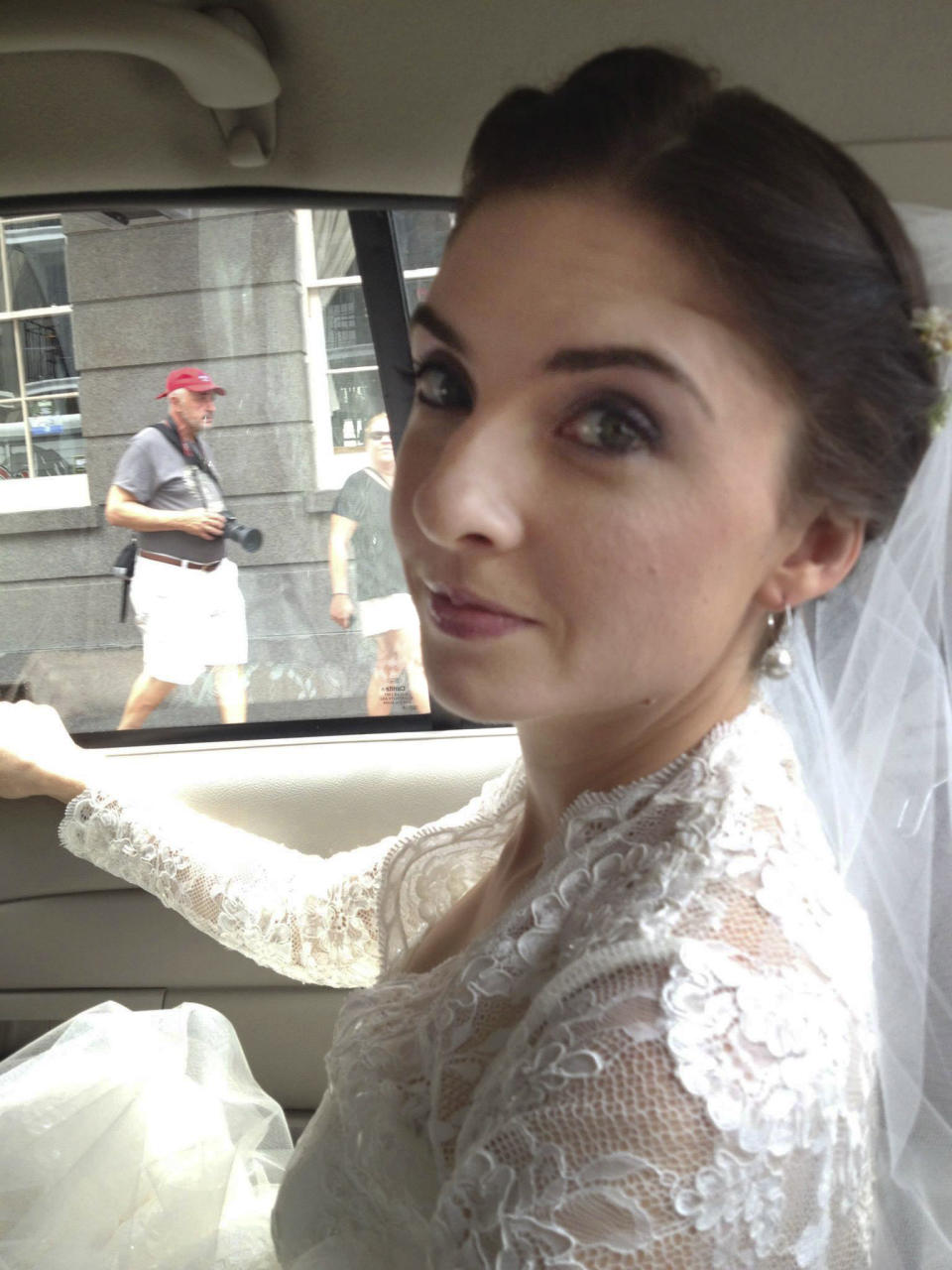 This Oct. 12, 2013 photo provided by Cheryl Winter shows her daughter, Shannon, riding in a taxi to her wedding in New Orleans, after her limousine failed to arrive. Cheryl Winter spent $500 for Hartford-based Travelers Insurance to cover Shannon’s destination wedding, where her biggest concern was a potential hurricane. The weather cooperated, but after the limo failed to show, they used the insurance policy to claim the deposit money they could not get back from the driver. (AP Photo/Nora Peach)