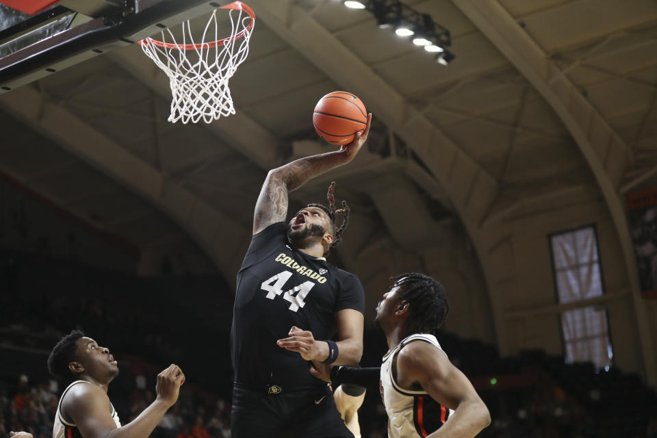 Colorado center Eddie Lampkin Jr. (44) shoots off a rebound as Oregon State center KC Ibekwe, left, and guard Dexter Akanno, right, defend during the second half of an NCAA college basketball game Saturday, March 9, 2024, in Corvallis, Ore. (AP Photo/Amanda Loman)