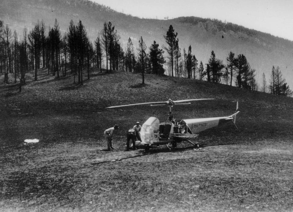 The body of a Mann Gulch fire victim is loaded aboard a helicopter in an August 1949 photo. The August 5, 1949 fire near Helena, Mont., killed 12 smokejumpers and a forest ranger. The Forest Service chartered this early helicopter to help in removal of the bodies from the remote mountain gulch where the victims died. On Thursday August 5 the U.S. Forest Service marks the 50th anniversary of the Mann Gulch fire, the first major catastrophe to befall what was then a still-young Forest Service smokejumper program and, until 1994, unsurpassed in the number of firefighter deaths in a single blaze. (AP Photo/USDA US Forest Service)