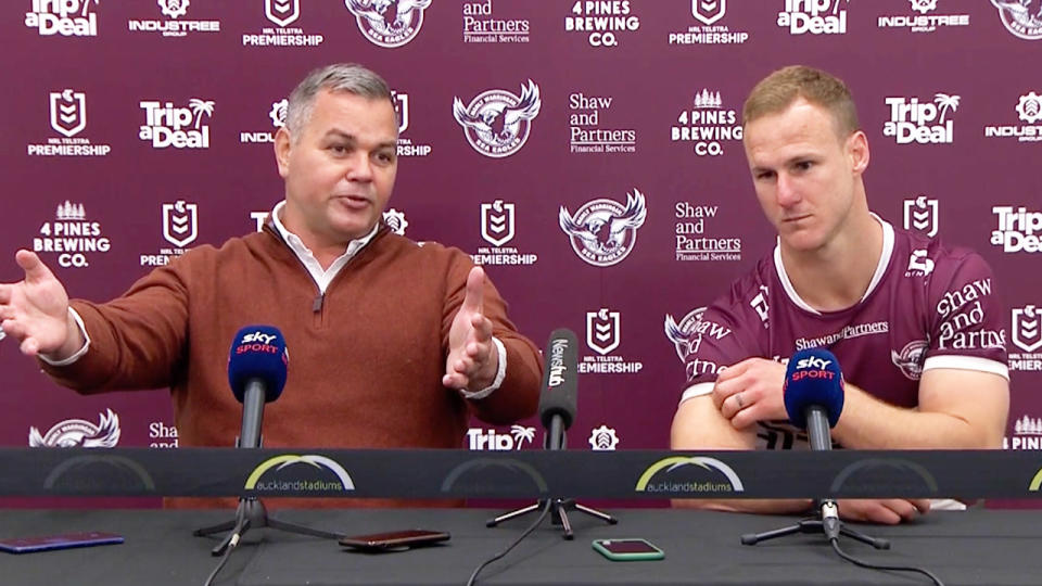 Anthony Seibold reacts and Daly Cherry-Evans sits during the interview.