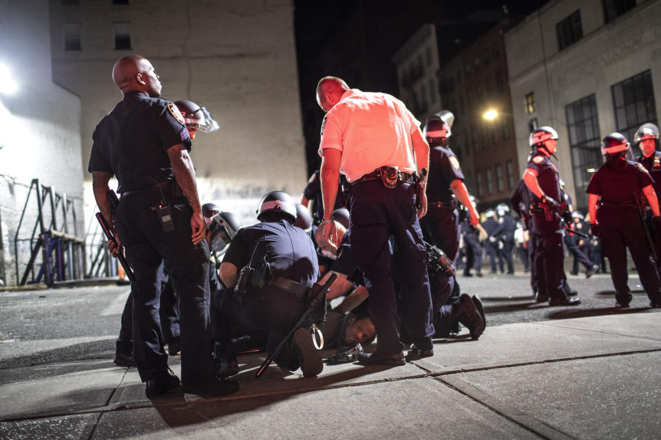 Police arrest a man in SoHo on Monday, June 1, 2020, in New York. Protests were held throughout the city over the death of George Floyd, a black man in police custody in Minneapolis who died after being restrained by police officers on Memorial Day. (AP Photo/Wong Maye-E)