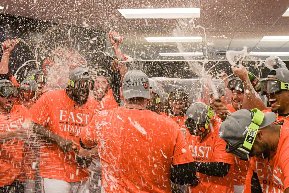 Sept. 28: The Baltimore Orioles celebrate in the locker room at Camden Yards after defeating the Boston Red Sox to win the American League East division.