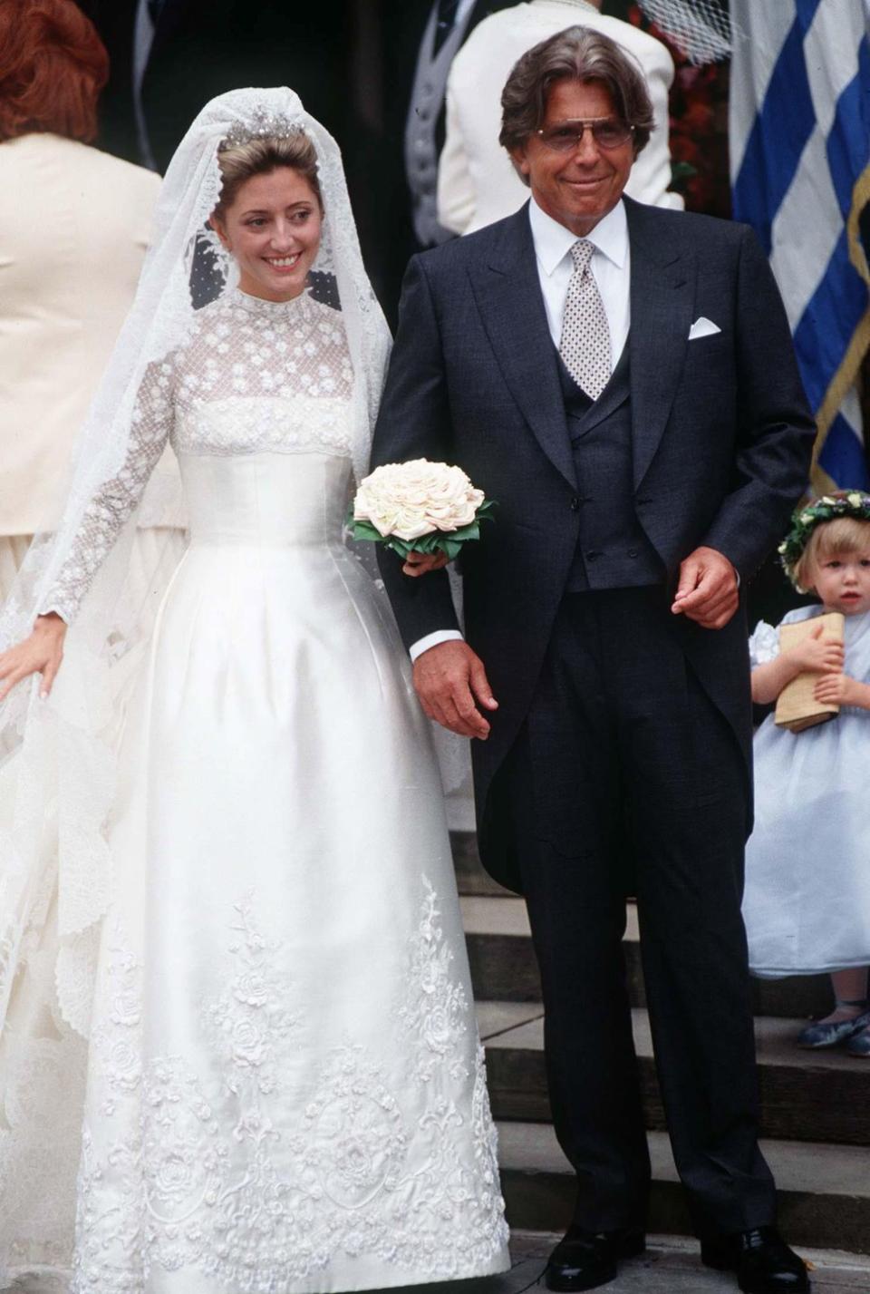 <p>When Marie Chantal Miller married Pavlos, the Crown Prince of Greece, in 1995, the American heiress opted for a pearl-encrusted Valentino gown with a fitted bodice and a high sheer neckline. </p>