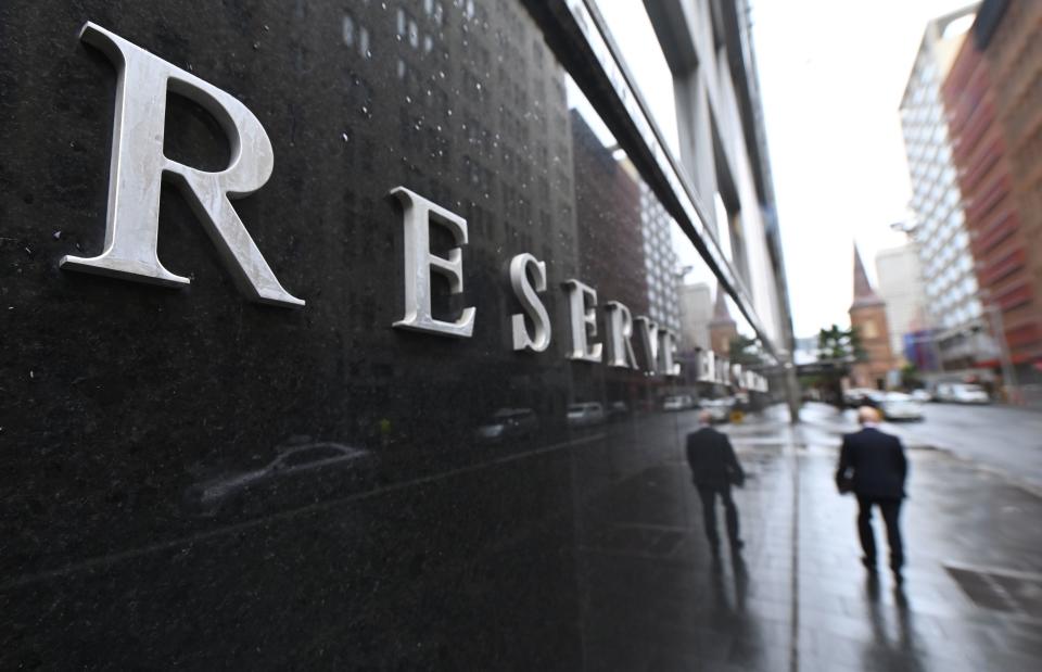 A pedestrian walks past the Reserve Bank of Australia.