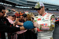 FORT WORTH, TX - NOVEMBER 06: Dale Earnhardt Jr., driver of the #88 National Guard Chevrolet, signs autographs for fans during driver introductions prior to the start of the NASCAR Sprint Cup Series AAA Texas 500 at Texas Motor Speedway on November 6, 2011 in Fort Worth, Texas. (Photo by Jared C. Tilton/Getty Images for NASCAR)