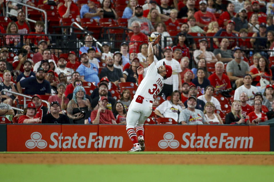 St. Louis Cardinals third baseman Jose Fermin (35) catches a fly ball for an out against Cincinnati Reds' Jonathan India during the fifth inning of a baseball game Friday, Sept. 29, 2023, in St. Louis. (AP Photo/Scott Kane)