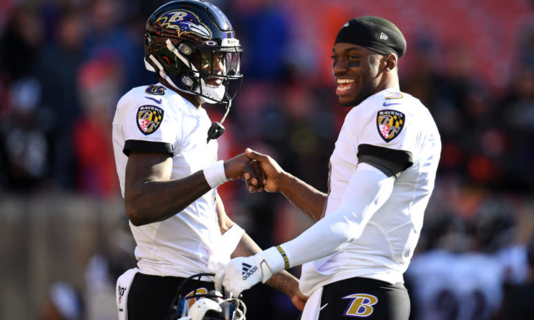 Lamar Jackson #8 and Robert Griffin III #3 of the Baltimore Ravens talking