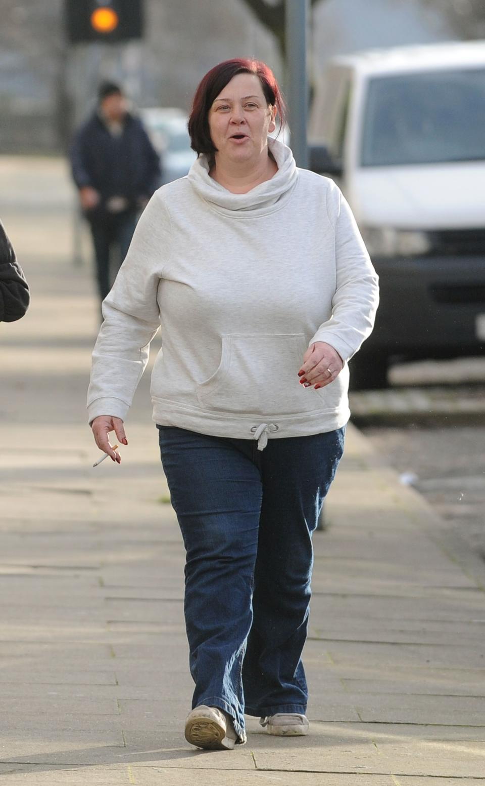 Deirdre Kelly known locally as White Dee walks along James Turner Street in Birmingham. (Photo by Joe Giddens/PA Images via Getty Images)