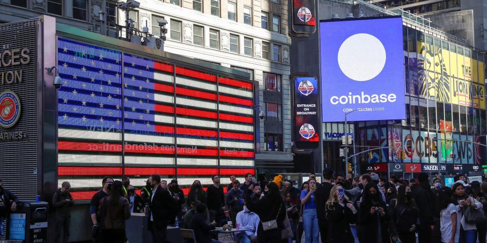 Coinbase Global watch as their listing is displayed on the Nasdaq MarketSite at Times Square in New York on April 14, 2021.