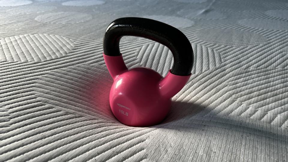 Testing the pressure relief of the Casper Snow mattress using a kettlebell during the at-home review process