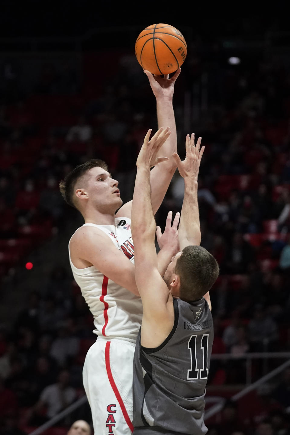 Arizona forward Azuolas Tubelis (10) shoots as Utah forward Riley Battin (11) defends during the first half of an NCAA college basketball game Thursday, Feb. 24, 2022, in Salt Lake City. (AP Photo/Rick Bowmer)