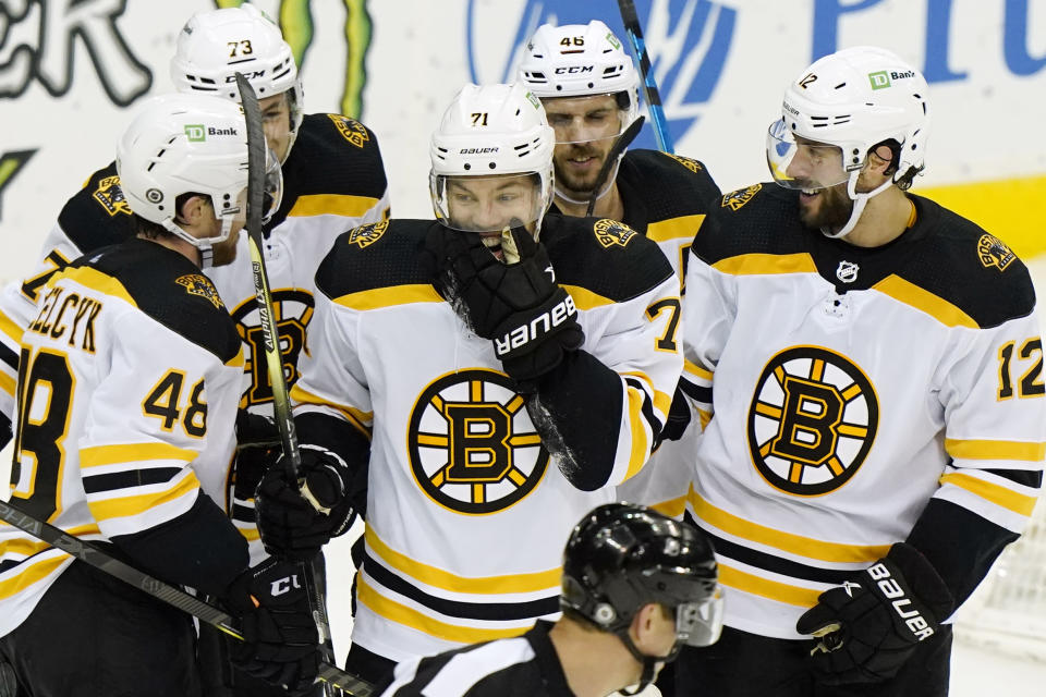 Boston Bruins left wing Taylor Hall (71) laughs with teammates after inadvertently scoring a goal against the New Jersey Devils during the second period of an NHL hockey game, Tuesday, May 4, 2021, in Newark, N.J. (AP Photo/Kathy Willens)