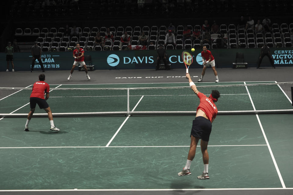 Chile's Alejandro Tabilo serves next to his teammate Chile's Tomas Barrios Vera during their doubles Davis Cup group A tennis match against Canada's Alexis Galarneau and Canada's Vasek Pospisil, in Bologna, Saturday Sept. 16, 2023. (Michele Nucci/LaPresse via AP)