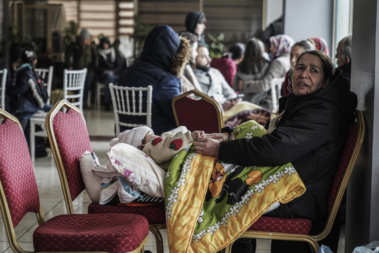 People gather in a shelter in Gaziantep, Turkey, Monday, Feb. 6, 2023. A powerful quake has knocked down multiple buildings in southeast Turkey and Syria and many casualties are feared. (AP Photo/Mustafa Karali)